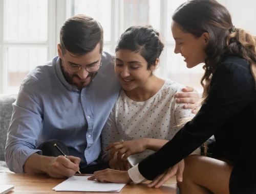 Married couple reviewing paperwork for a spousal sponsorship application to Canada